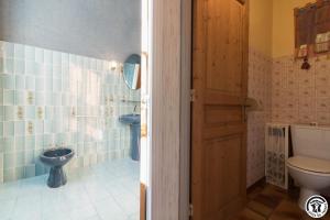 a bathroom with a toilet and a sink at Ancienne ecole in Montbrun-Bocage +27 photos