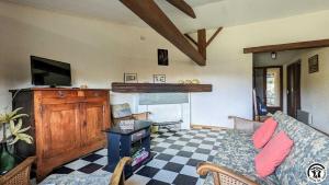 a living room with a couch and a fireplace at L'ouastadet in Aspret-Sarrat