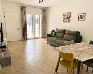 a living room with a couch and a table at Casa Vacanze Tellus in Ciampino