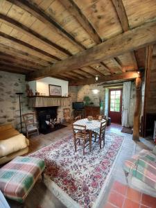 a living room with a table and a fireplace at Chez pailhas in Régades