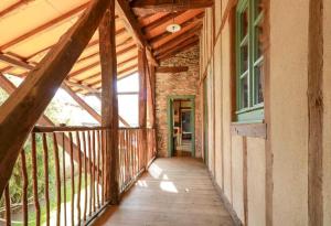 an empty porch of a house with a wooden walkway at Chez pailhas in Régades