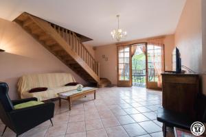 ein Wohnzimmer mit Treppe und Sofa in der Unterkunft Gèze in Chein-Dessus