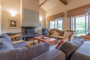 a living room with two couches and a fireplace at Le clos saint-paul - nature in Estadens