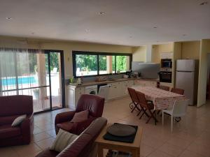 a kitchen and living room with a table and chairs at Le petit clot de pey in Esperce