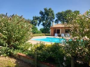 a villa with a swimming pool in a garden at Le petit clot de pey in Esperce