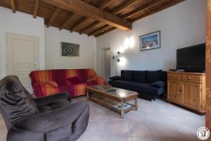 a living room with a couch and a table at Chantecler in Pibrac