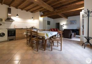 a kitchen and dining room with a table and chairs at Chantecler in Pibrac
