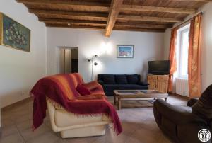 a living room with a couch and a table at Chantecler in Pibrac +10 photos