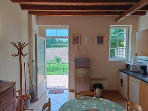 a kitchen with an open door to a yard at Granny in Pibrac +13 photos