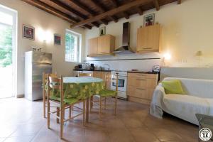 a kitchen with a table and chairs in a room at Granny in Pibrac