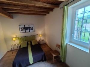 a bedroom with a bed and a large window at Granny in Pibrac