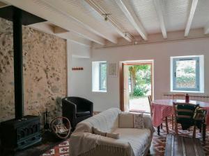 a living room with a couch and a table at Le gar in Labarthe-Rivière