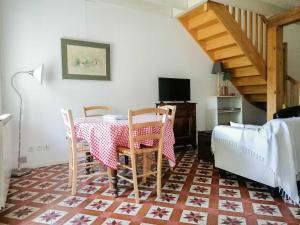 a dining room with a table and two chairs at Le gar in Labarthe-Rivière +6 photos