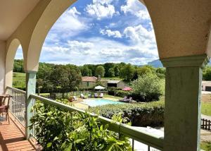 a view from the balcony of a house with a swimming pool at Le clos saint-paul - comminges in Estadens