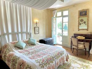 a bedroom with a bed and a desk and a piano at Le clos saint-paul - comminges in Estadens +21 photos
