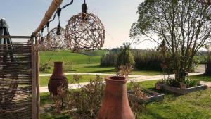 two vases sitting in a garden with a chandelier at Gîte Baugnac N°2 in Lavalette