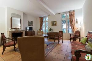 a living room with a couch and a fireplace at Le parc des moutous in Aurin