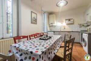 a kitchen with a table with a polka dot table cloth at Le parc des moutous in Aurin
