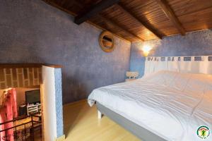 a bedroom with a bed and a tv in it at Au village in Roques Sur Garonne +18 photos