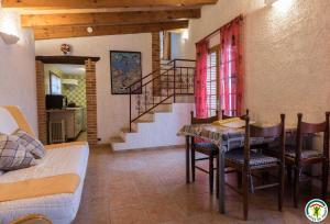 a living room with a table and a staircase at Au village in Roques Sur Garonne