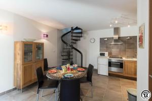 a kitchen and dining room with a table and chairs at Le hérisson in Aurignac