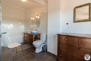 a bathroom with a toilet and a sink and a tub at Le hérisson in Aurignac +22 photos
