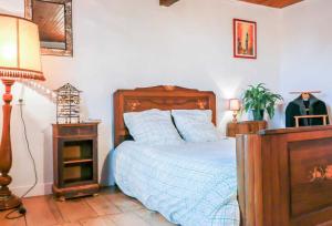 a bedroom with a bed and a table with a lamp at Les platanes in Aignes