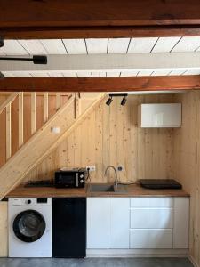 a kitchen with a sink and a washing machine at Domek w lesie in Gnojno +13 photos