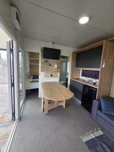 a kitchen with a wooden table in a room at Mobile house Jasna in Kalnik +7 photos