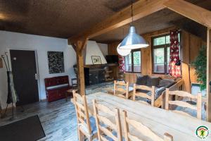 a living room with a large wooden table and chairs at Le gîte de la coume in Garin