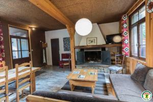 a living room with a couch and a table at Le gîte de la coume in Garin