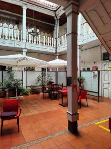 a large room with tables and chairs and umbrellas at HOTEL DUX in Tunja