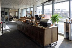 an office with a counter with a cash register at Hôtel Lodge In Paris 13 in Paris +53 photos