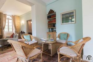 a living room with chairs and a table at Château sud in Cessales