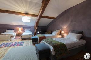 a hotel room with two beds and a chair at Château sud in Cessales