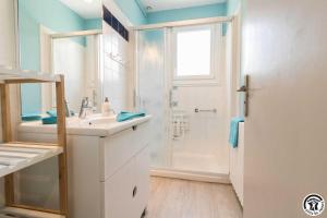 a white bathroom with a sink and a shower at Les lilas in Aussonne +21 photos