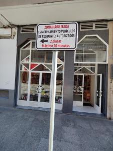 a street sign in front of a store at Apartamento La Ballena 2 - Las Huertas in Santoña
