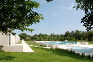 a group of three swimming pools in a yard at La grange des rampeaux in Saint-Lys