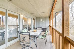 a dining room with a table and chairs on a porch at Family-Friendly Condo 1 Mi to Silver Dollar City! in Branson West