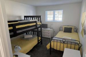 a bedroom with two bunk beds and a desk at Chalet Saint-Sauveur with heated pool during Summer and Ski in Ski out! in Saint-Sauveur-des-Monts +22 photos