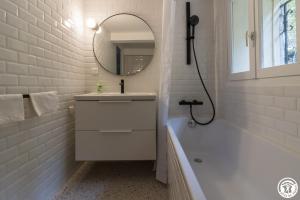 a bathroom with a sink and a tub and a mirror at Maison jéricho in Saint-Ignan +51 photos