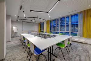 a conference room with a long table and chairs at Flightgate Munich Airport Hotel, a member of Radisson Individuals in Hallbergmoos
