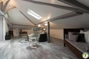 a living room with a couch and a rocking chair at Gîte de pene blanque in Arbas