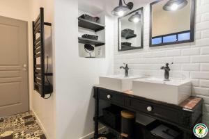 a bathroom with two sinks and a mirror at Gîte de pene blanque in Arbas +31 photos