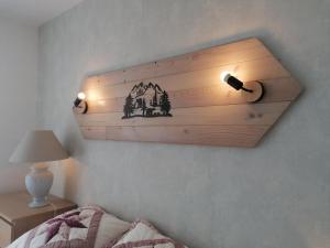 a bedroom with two lights on the wall at L'encantador in Saint-Mamet +7 photos