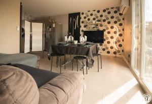 a living room with a table and a couch at La maison d'emy in Vernet