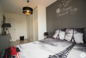 a bedroom with a bed with the words on the wall at La maison d'emy in Vernet