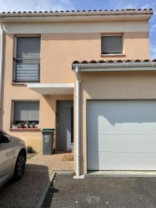 a garage door in front of a house at La maison d'emy in Vernet