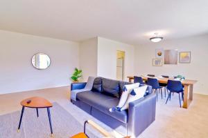 a living room with a blue couch and a table at Prime Location! Spacious & Comfy in Arlington +27 photos