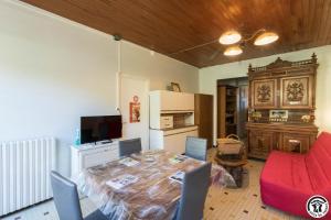 a living room with a table and a kitchen at Gîte les ecureuils in Montclar-de-Comminges